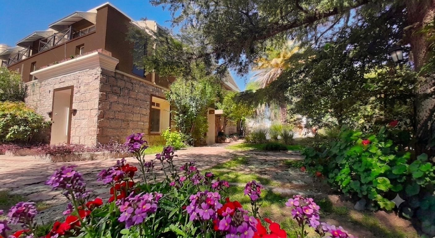 Fachada del Hotel Uritorco con jardín y flores, Capilla del Monte